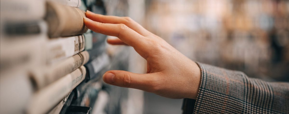 A,Hand,Reaches,Out,To,Touch,The,Spine,Of,A