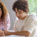 Mother helping her son with homework at home