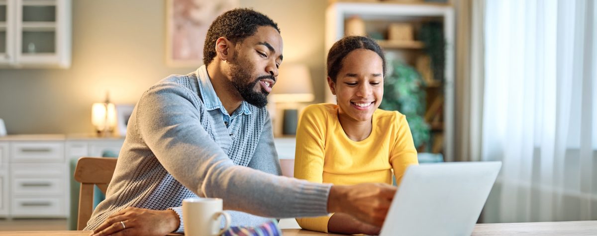 father helps daughter with school work and budgeting