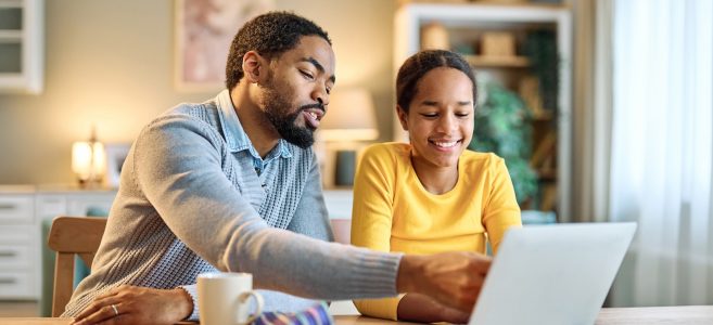 father helps daughter with school work and budgeting