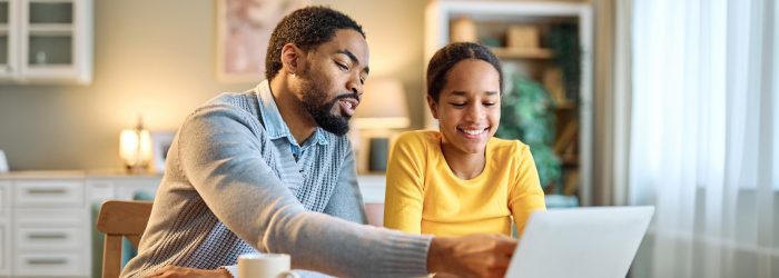 father helps daughter with school work and budgeting