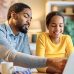 father helps daughter with school work and budgeting