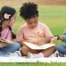 Kids doing summer school on a blanket outside